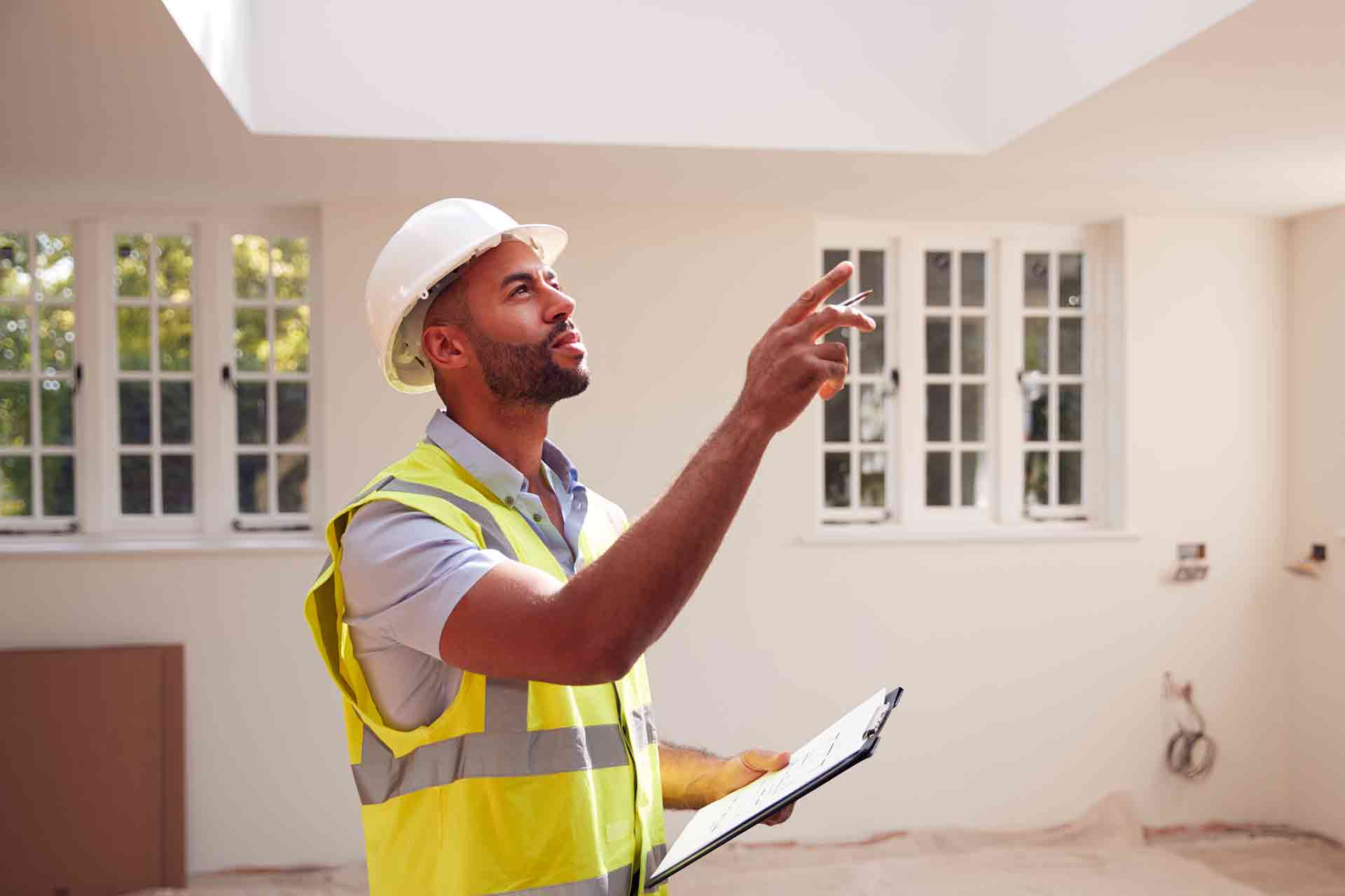 Third Party Wall Surveyors Cambridge reviewing plans between two parties during a dispute
